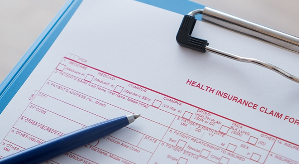 The copy of the printable CMS-1500 claim form with a pen